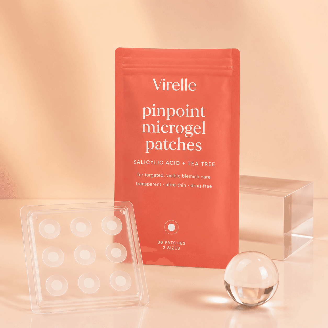 Virelle pinpoint microgel patches pouch with the patch tray and glass props on a peach set